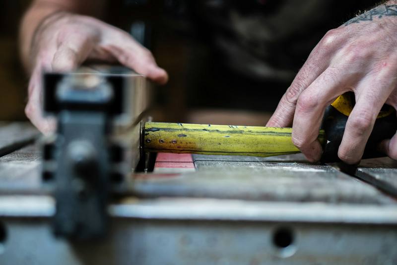 Hands extending a steel tape measure to take a measurement